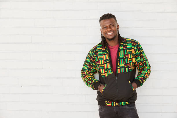 istock Smiling young man leaning against a brick wall outside 1326137912