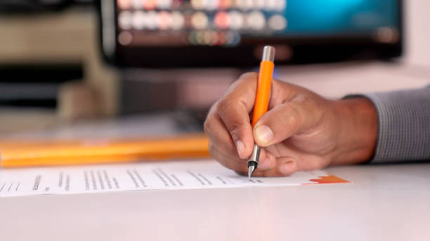 istock Signing documents with a pen making the signature sitting at the desk 1326137916