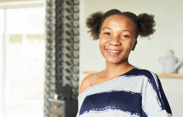 istock Young woman laughing while standing alone in her home 1326138102