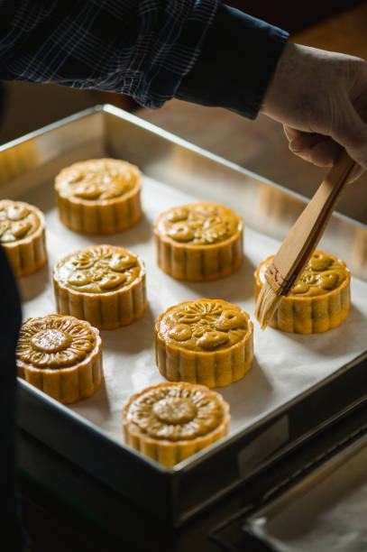 istock Baker painting with eggs dough to make Homemade Chinese mooncake on baking tray 1326140085
