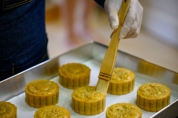 istock Baker painting with eggs dough to make Homemade Chinese mooncake on baking tray 1326140232