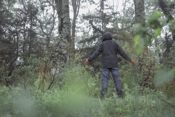 istock man on his back with open embrace in the forest on a rainy day 1326141205