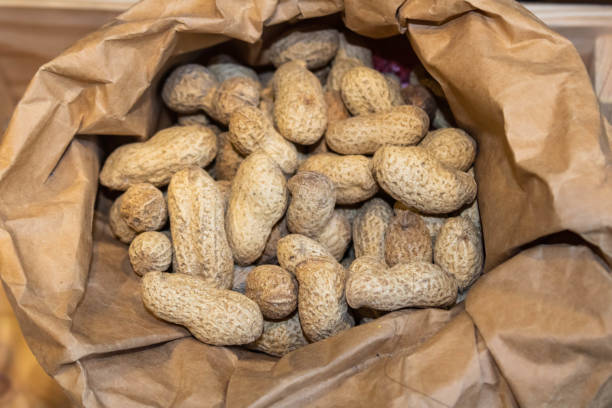 istock Peanuts in shell in an open paper bag, top view 1326141231