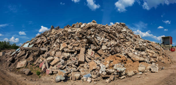 big pile of construction rubble under a blue sky