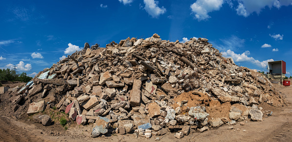 Rubble from a demolished industrial building is being recycled on a construction site.