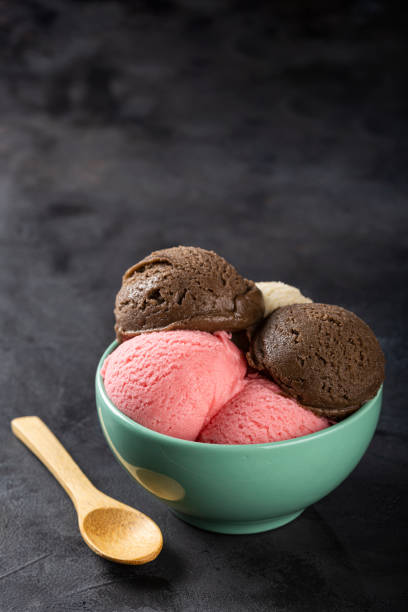 istock Bowl with Neapolitan ice cream on dark background. 1326143886