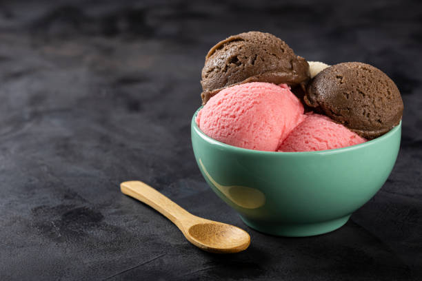 istock Bowl with Neapolitan ice cream on dark background. 1326143887