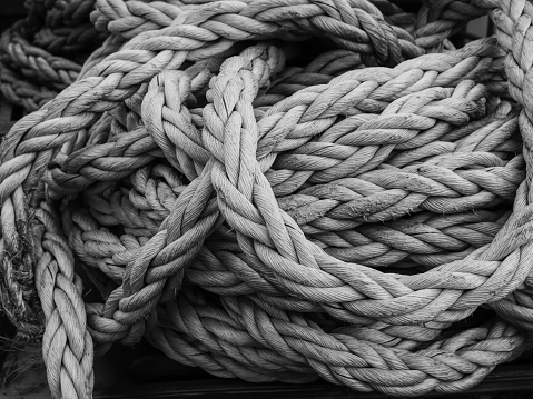 Thick, coiled ship ropes in the port