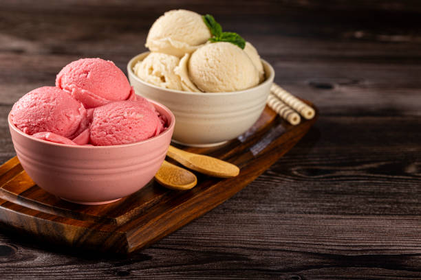 istock Bowls with strawberry and vanilla ice cream. 1326144096