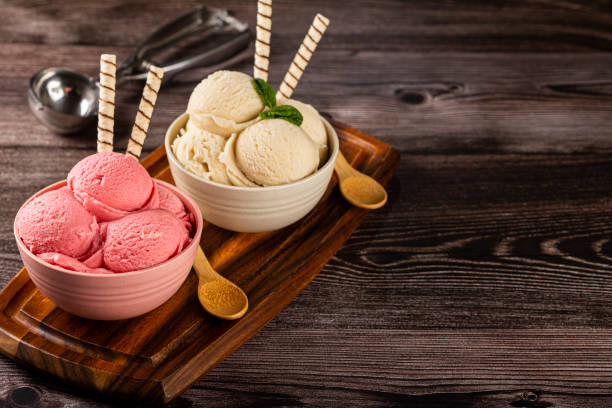 istock Bowls with strawberry and vanilla ice cream. 1326144118