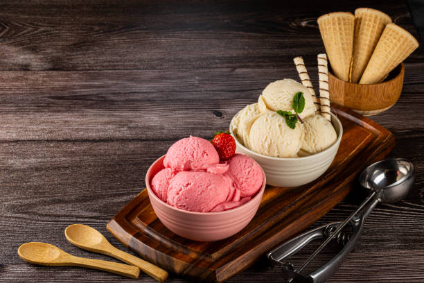 Bowls with strawberry and vanilla ice cream.