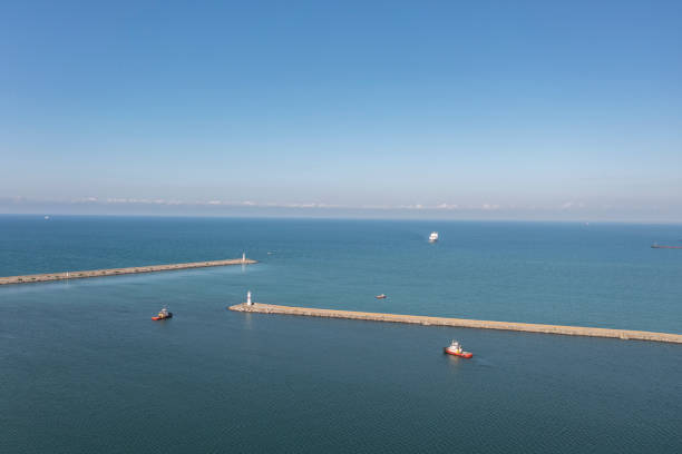 Harbour tugboat guides a cargo ship into the harbour of Samsun - Turkey - Taken with DJI Mavic 2 Pro, You can see more shipping concept images in my portfolio.