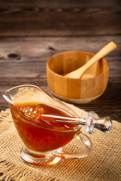 istock Honey in glass bowl on the table. 1326145219