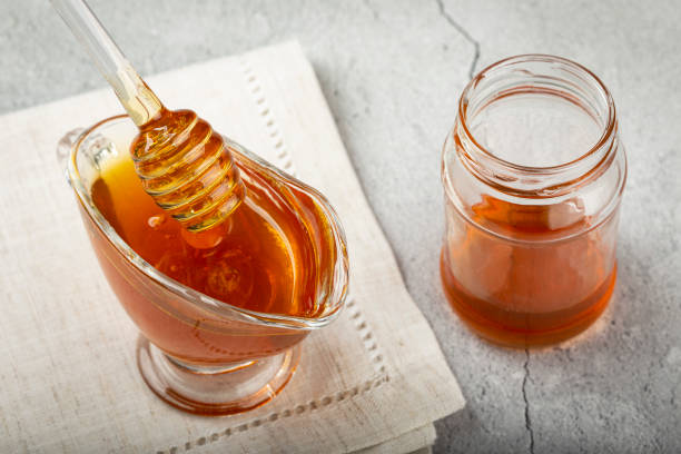 istock Honey in glass bowl on the table. 1326145260