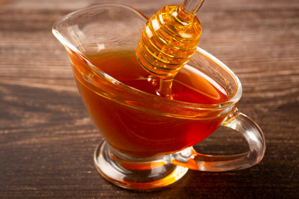 istock Honey in glass bowl on the table. 1326145277
