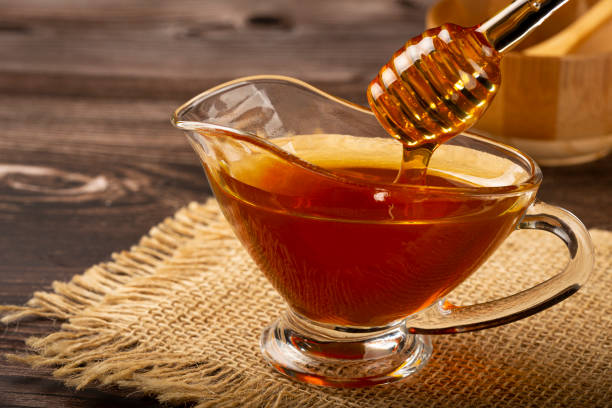 istock Honey in glass bowl on the table. 1326145286