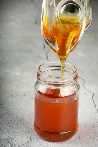 istock Honey in glass jar on the table. 1326145313