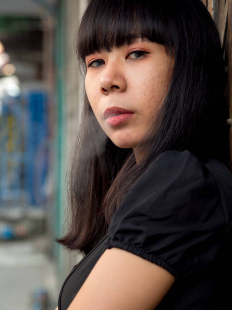 istock young Asian woman smoking 1326145663