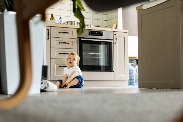 istock Baby boy sitting in kitchen 1326148726