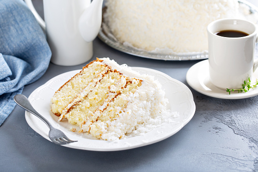 Coconut layer cake slice on a plate