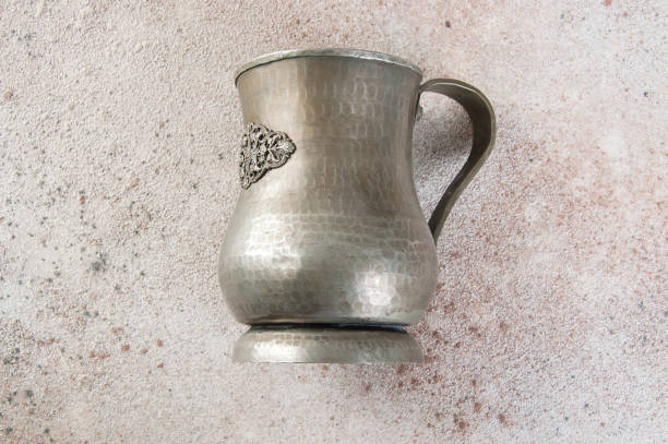 istock Antique metal cup on a concrete background. 1326150007
