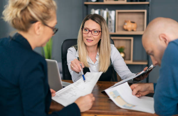 istock Financial advisor explaining paperwork to young couple 1326152652