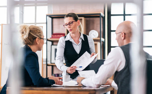 istock Financial advisor explaining paperwork to young couple 1326152659