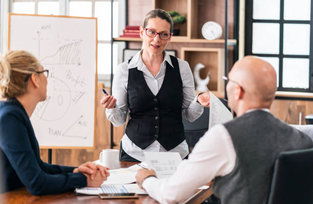 istock Financial advisor explaining paperwork to young couple 1326152661