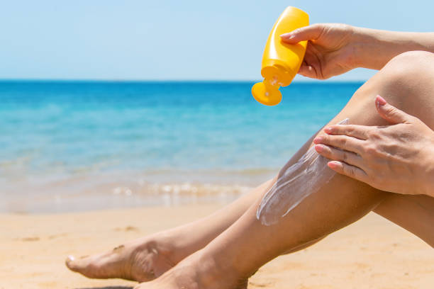istock A woman smears her feet with sunscreen. Selective focus. 1326153256
