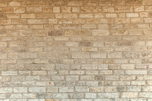 limestone natural briks wall. Cream and white brick wall texture background. Brickwork or stonework flooring interior rock old pattern stone design stack.