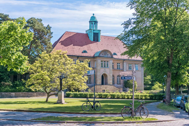 Berlin, Germany - June 3, 2021: Architectural monument former Town Hall Nikolassee with its narrow central risalit, arched openings, a semicircular gable field and an open staircase, now used by the Berlin police
