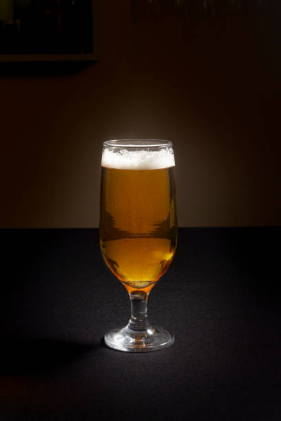 istock Glass of beer isolated on a dark background 1326161413