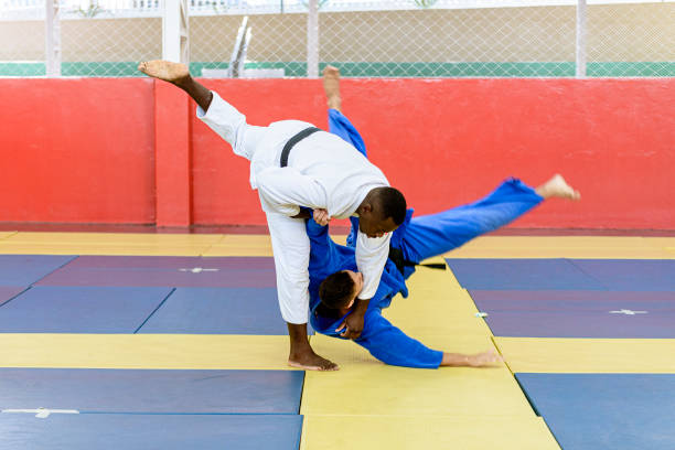 Judo athlete entering blow during fight stock photo