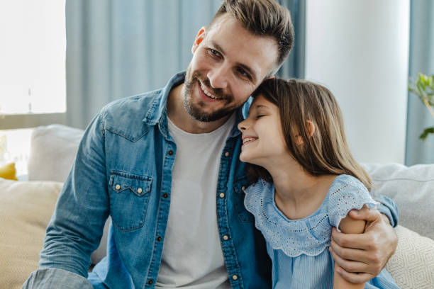 istock Father and daughter embracing at home 1326168491