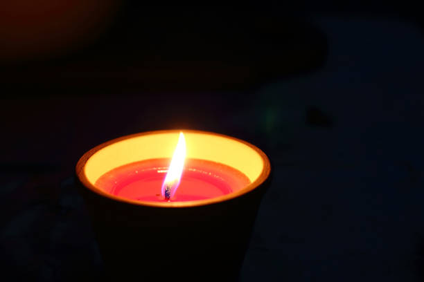 burning single candle in dark. blackout and power failure concept. - advent electric item lights bildbanksfoton och bilder