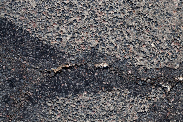 istock part of an asphalt road with damage 1326172620