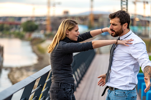 Beautiful Young Woman with Long Hair is Having a Conversation Fight with her Handsome Boyfriend. They are Walking near the River Bank and Trying to Solve the Emotional Problems.