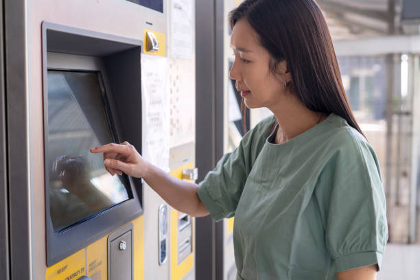 istock Woman with mask buying a train ticket at the automatic ticket vending machine 1326174220
