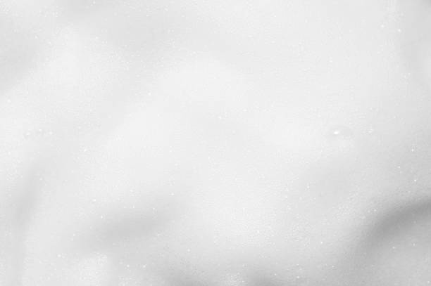istock White foam texture close up background. Soapy substance with bubbles backdrop. Creamy shampoo surface. Shower gel, washing liquid smears wallpaper. Cosmetic product foamy smudges 1326180612