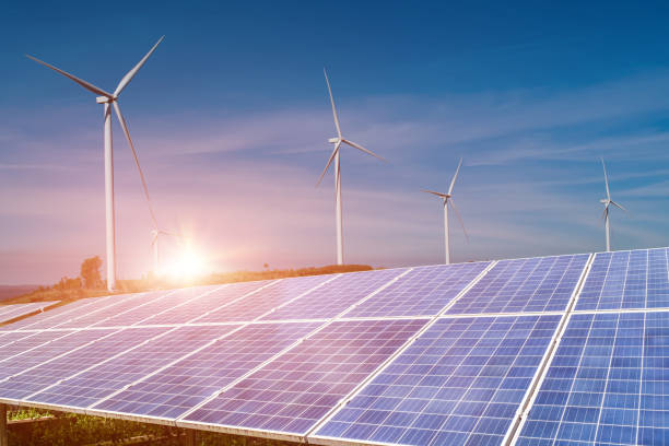 istock solar panels with wind turbines against blue sky background 1326187070