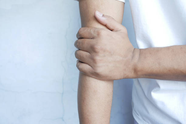 istock man suffering pain in hand close up 1326190570