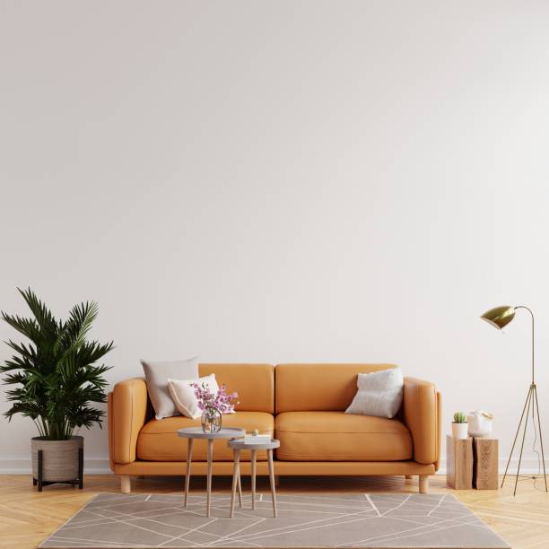 istock Living room interior wall mockup in warm tones with leather sofa on white wall background. 1326191351