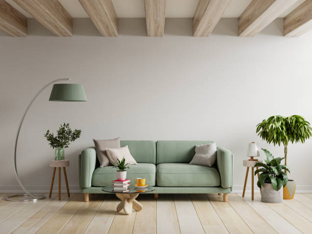 green sofa in modern apartment interior with empty wall and wooden table. - decoraties stockfoto's en -beelden