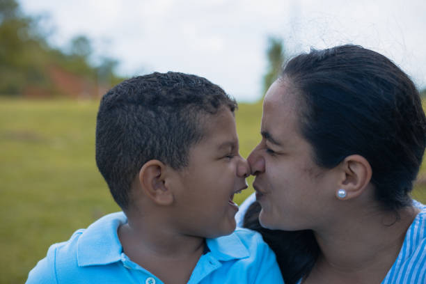 Latino Boy Playing With His Latina Mom's Nose