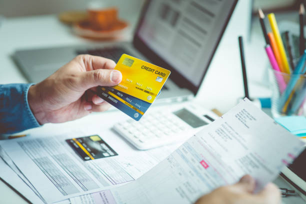 Person paymant bill with credit card on desk table.business financial and cost Person paymant bill with credit card on desk table.business financial and cost concepts bank statement stock pictures, royalty-free photos & images