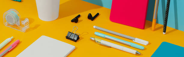 istock Colorful notepads, pens and paper cup on orange table 1326194977