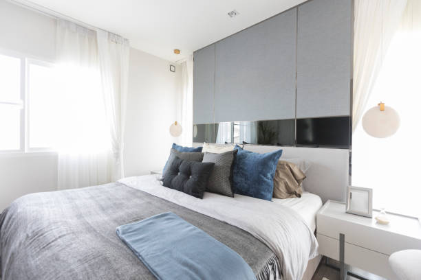 istock Modern white and blue bedroom with armchair 1326198422