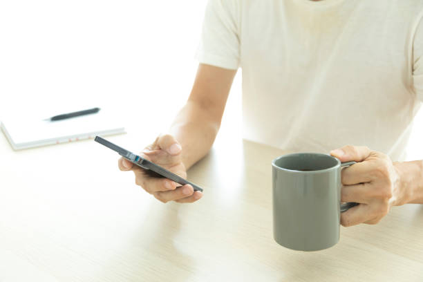 istock Close-up image of young man using smartphone at home. 1326198515