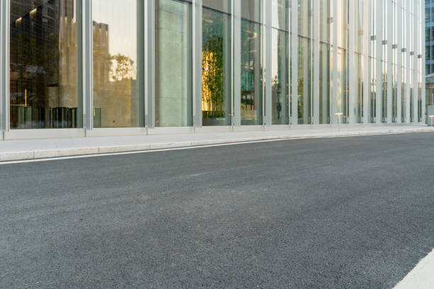 istock empty asphalt road with modern office buildings in downtown. 1326198547