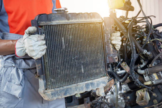 istock Auto mechanics holding broken car radiator in auto service, technician doing the checklist for repair car engine in the garage 1326198574